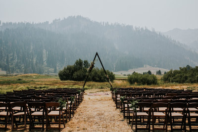 wedding aisle with chairs and mountains in background
