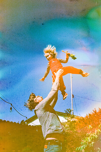 photo of dad tossing son into the air taken on film and souped