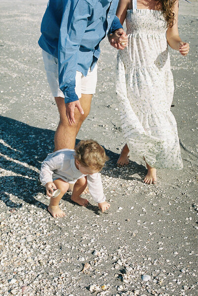 family playing on the beach by destination wedding photographer