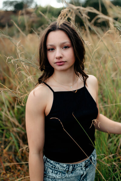 young woman standing in a field
