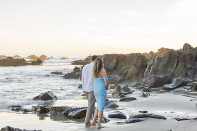candid walking away maternity photo at the beach