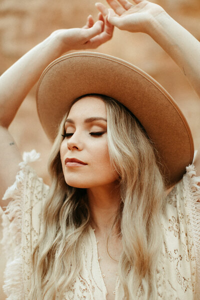 Boho bride posing in hat