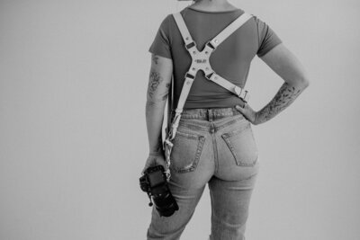 woman holding camera with harness