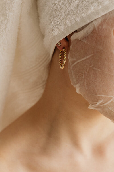 This serene image captures the peaceful aftermath of a facial treatment at Book Sothana, a premier day spa in Jacksonville, FL. Featuring a close-up of a woman wrapped in a towel with a hydrating facial sheet mask, this photo symbolizes the gentle, restorative experience that Book Sothana is known for. Located in Jacksonville, FL, Book Sothana offers luxurious facials designed to nourish and refresh tired skin, leaving clients glowing and deeply relaxed. Whether you're looking to reset your skincare routine, prepare for a big event, or simply enjoy a moment of self-care, a professional facial treatment here is the perfect choice. Book Sothana specializes in facials that blend expert technique with soothing relaxation, helping your natural beauty shine. To learn more about facials in Jacksonville, FL, or book your customized treatment, visit https://booksothana.com/ or call (904) 597-0867.