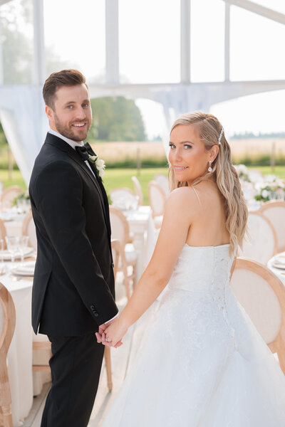 Bride and groom looking at camera