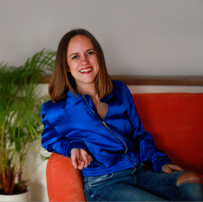 Adele Wimsett sits on a couch