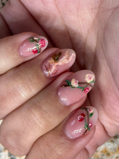 Detailed flowers painted on a gel nail done by Kristal