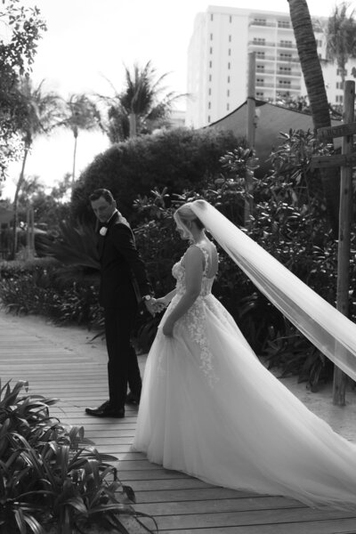 Bride and groom walking first look miami beach 