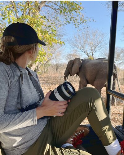 Wildlife photographer Stephanie Vermillion on safari looking out at an elephant