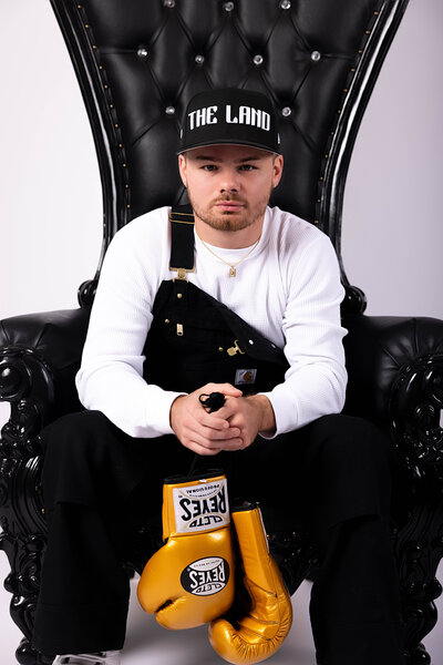 professional boxer posing on chair in with reva davis photography