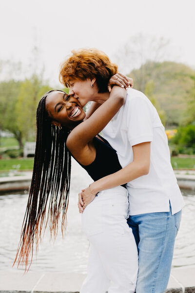 Juma Waganda with her arms around her partner Andy while he kisses her on the cheek