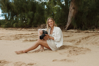 Emily, one of  Sierra Bertini Photography associate sitting in the sand at a beach in Maui