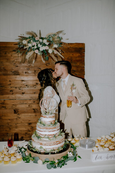 couple kissing after their cake cutting taken by dallas wedding photographer