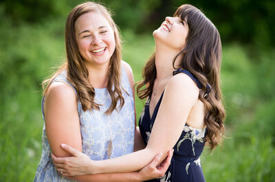 Ottawa family photography showing two adult sisters laughing and hugging during their session