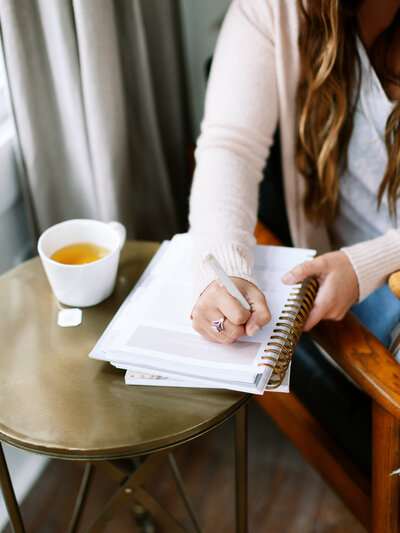 Woman writing in a journal for mindset coaching