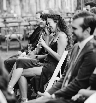 wedding guests laughing during wedding ceremony