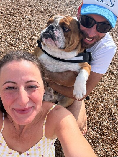 Mariella and her dog on the beach in the sun