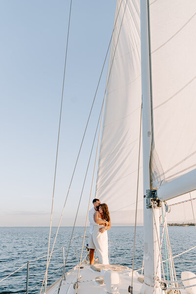 Couple cuddling on sailboat in Santa Barbara