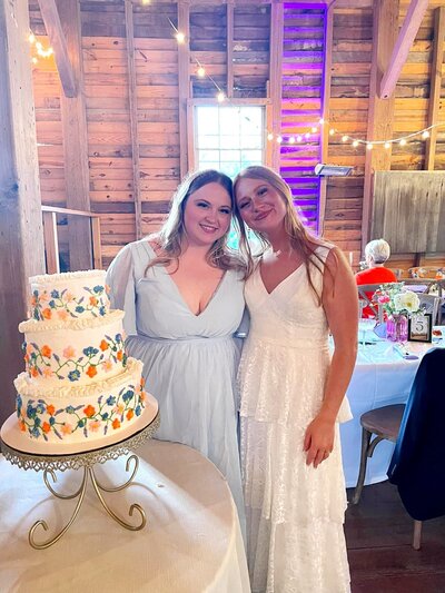 two girls in front of cake