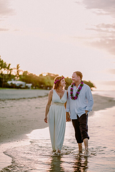 pink sky and bridal couple on beach