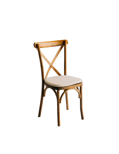 A wooden crossback chair with white cushion.