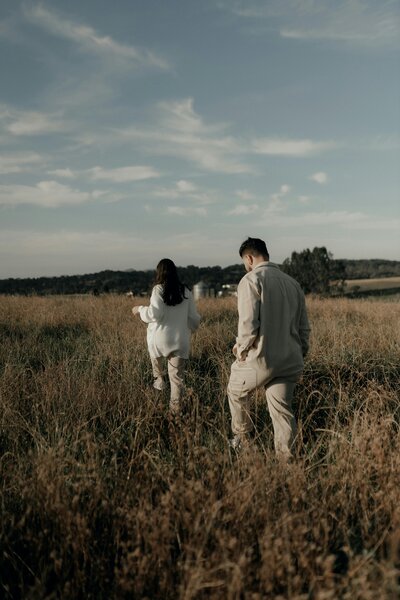 Woman and man walking along the same path but at a distance.