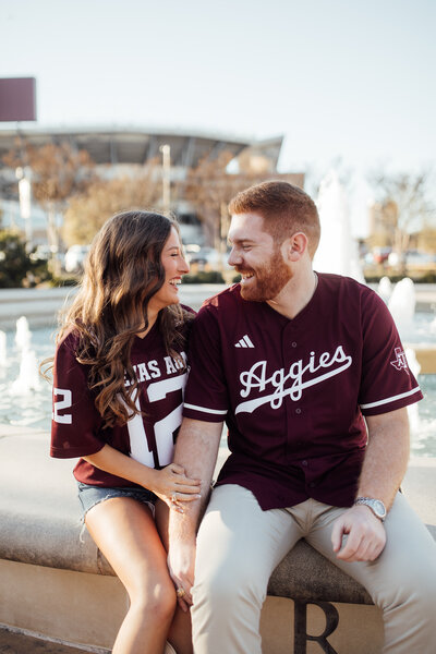 Senior girl smiles in front of water fountain