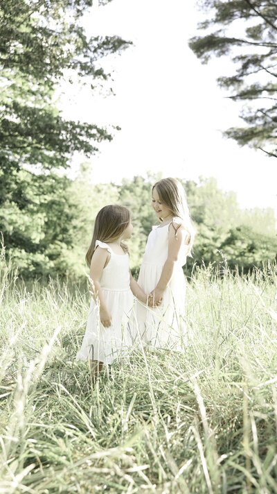 two sisters holding hands during their Asheville Family Session
