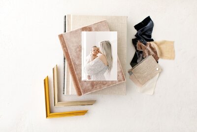 Printed Newborn Photography Alexandria photo album cover with frame styles on table.