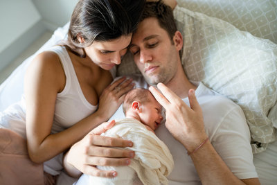 Mother and father holding their newborn daughter