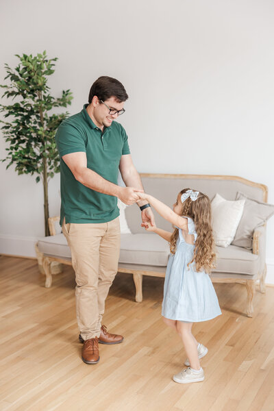 a dad dancing with his daughter