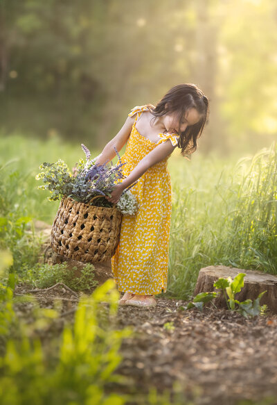photo of young girl holding flower basket in a field during spring minis in sacramento ca