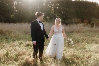 A bride and groom at Markovina Wedding Venue being photographed at sunset by Tashina Narelle