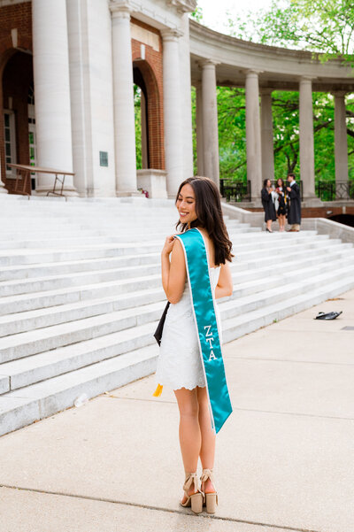 Vanderbilt University steps of Wyatt Center Senior girl holding sorority stole for graduation