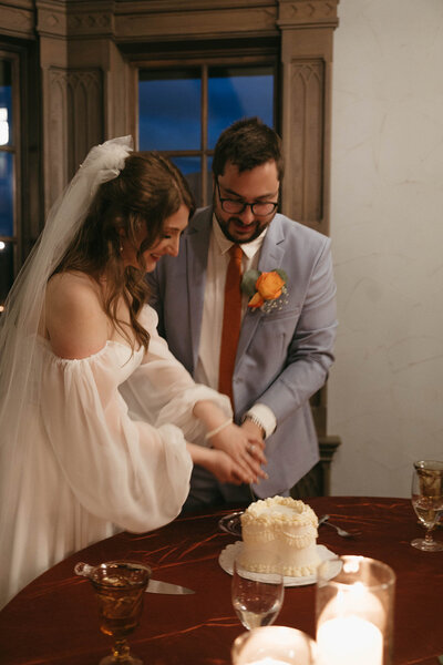 Bride and groom cutting cake, representing full service wedding planning in Eugene by Birdie June Events and Rentals. 