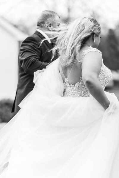 Bride and groom captured in motion on their wedding day. Stunning candid shot by Jackson Ms Wedding Photographer.