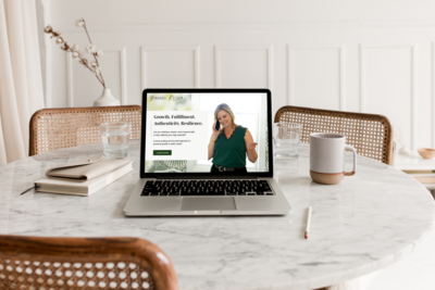 Home page of a minimalist website featuring a photograph of a woman business owner on the phone