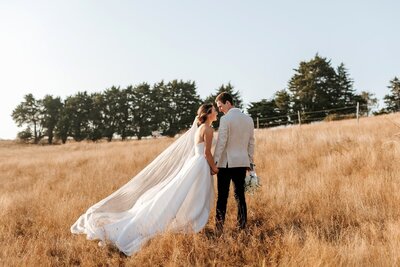 Sunset wedding photos in an outback field with a bride and groom