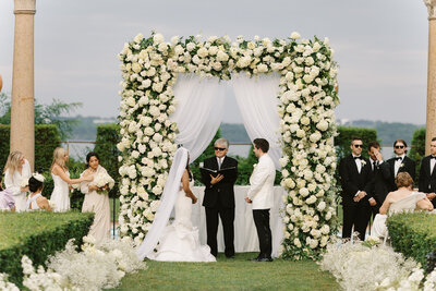 Wedding arch with white hydrangeas plus babies breath aisle flowers 