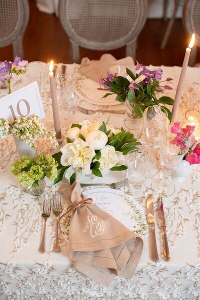Reception table decorated with candles and beautiful flowers
