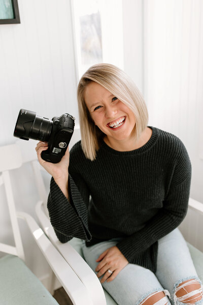 Photographer holding a camera and smiling - Park Rapids, Minnesota