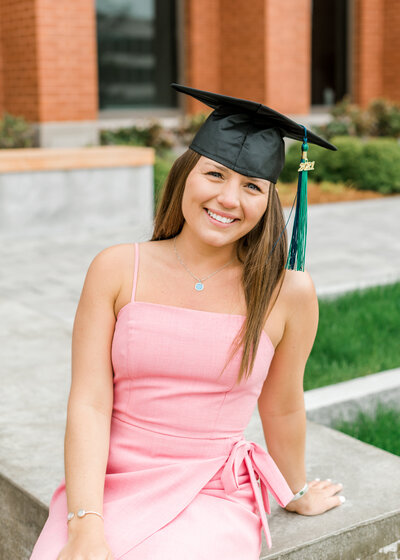 senior grad sitting on stairs