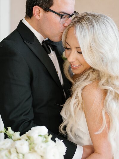 Bride and groom portrait classic tux and white bouquet