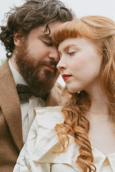 Couple kissing with the mountains in the background