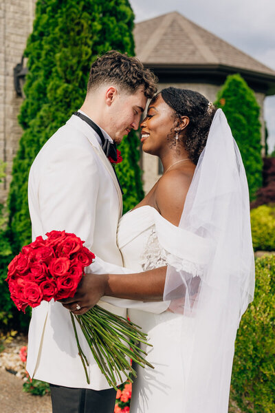 Bride and groom touching foreheads in front of Naimoli Estate, a wedding venue in Hopkinsville, KY.