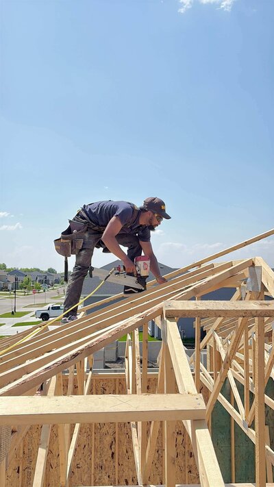 Owner framing roof with nail gun