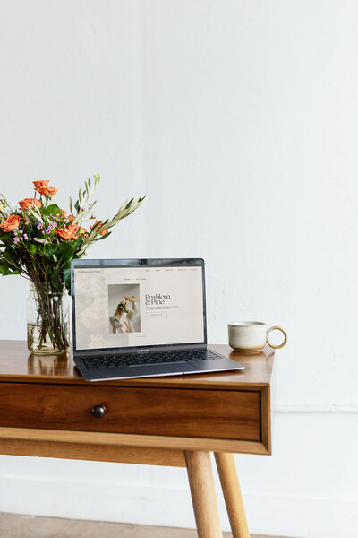 Laptop with coffee showing showit web design for luxury photographers, Palme Design Co