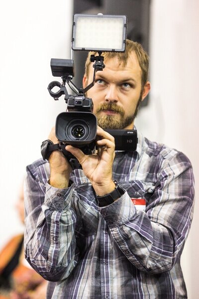 Jeremy Francis holding a camera at an event