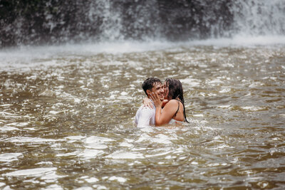 A couple embraces under a waterfall at Brush Creek Falls in Princeton, West Virginia.