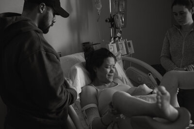 woman holding newborn on chest